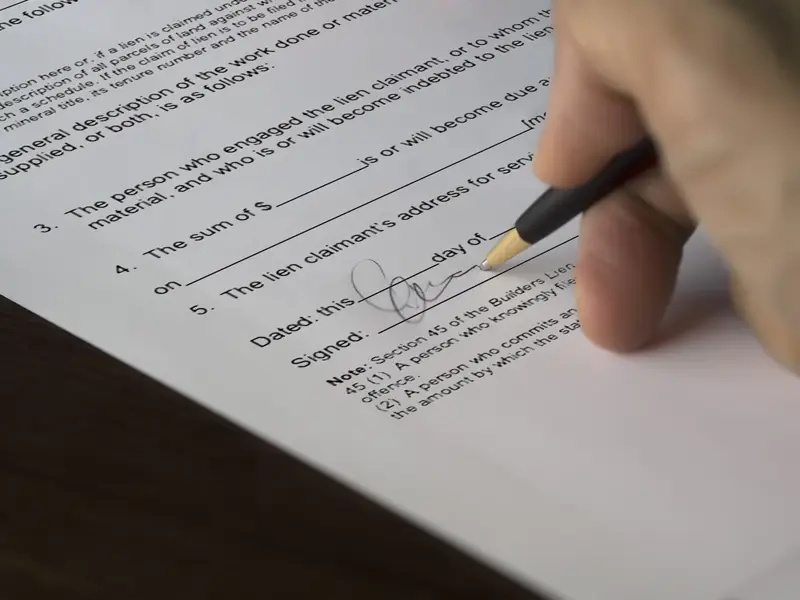 Contractor filling out a builder lien form to place on the home of a negligent owner.