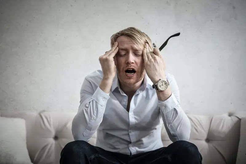 A homeowner holding his head in stress as he found out a contractor placed a lien on his house.