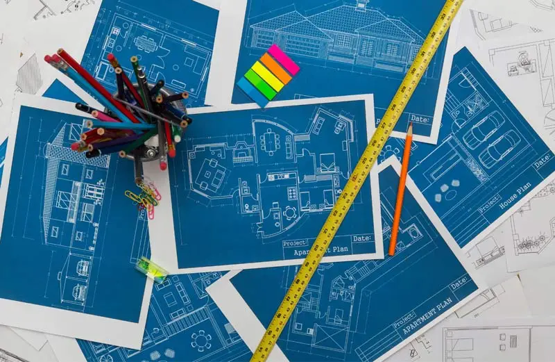 Blueprints of a construction project laid out being analyzed by a construction lawyer