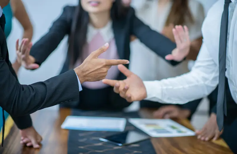 A construction lawyer acting as a mediator between two angry parties in a construction dispute trying to keep them calm and civil