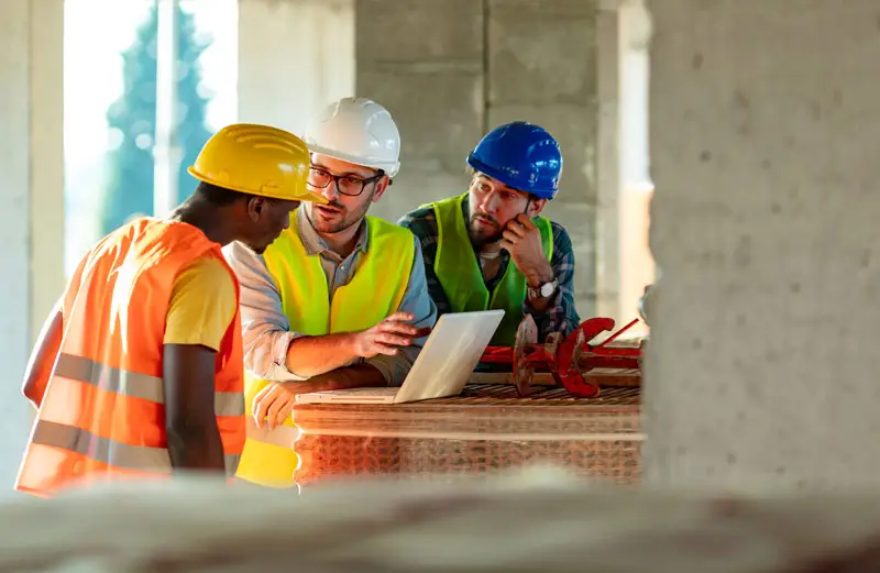 contractors having construction dispute who are negotiating to resolve the issue while going over blueprints