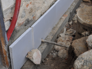 underpinning structural enhancements being added to a building foundation after obtaining a underpinning agreement.