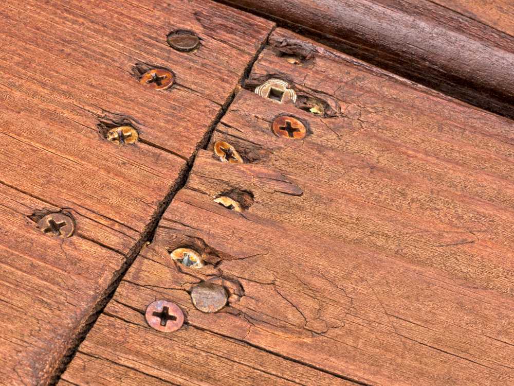 photograph taken by home owner of a buch of screws in wood beems showing poor worksmanship of a contactor