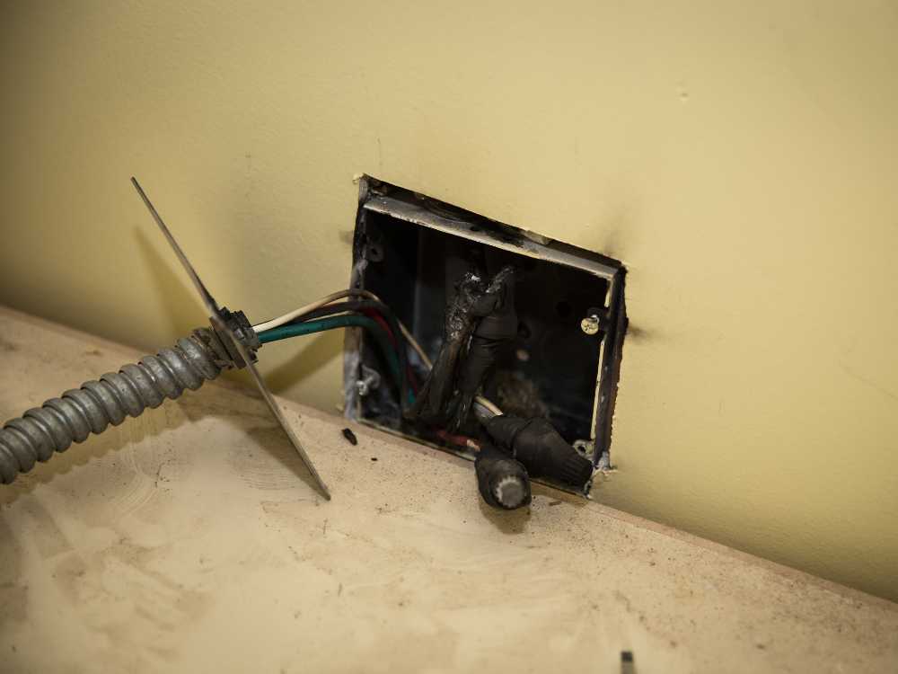 a poorly wired electrical outlet showing poor worksmanship of a contractor