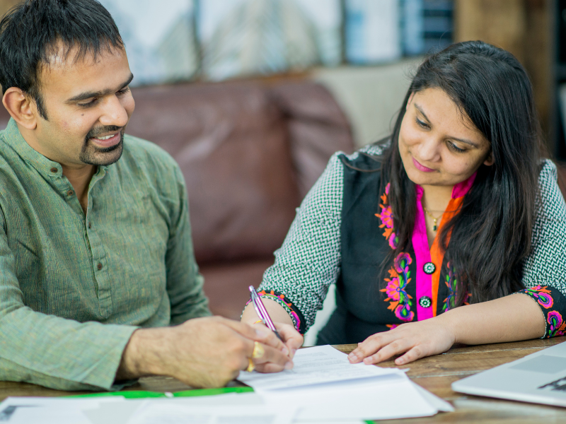 A married Indian couple filing evidence to show their intent to move to Canada after successful sponsorship via Family Class